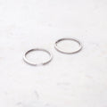 Flatlay view of Bar CZ Small Hoop Earrings in Sterling Silver, 1.25 inch