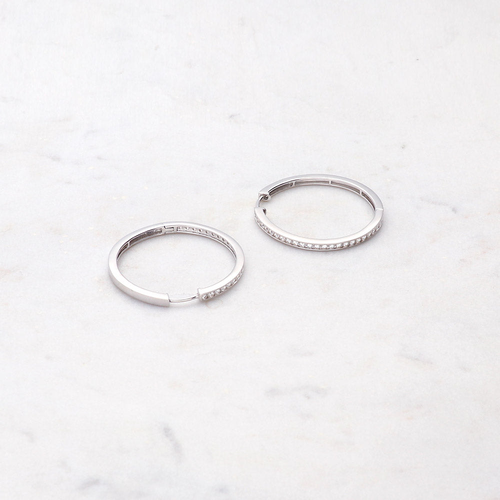 Flatlay view of Bar CZ Small Hoop Earrings in Sterling Silver, 1.25 inch