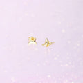 Flatlay view of Crescent Moon Cartilage Stud Earrings in Sterling Silver, Yellow Gold Flashed
