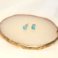 Flatlay view of Solitaire 1.6ct CZ Cartilage Stud Earrings in Sterling Silver, Amethyst Color