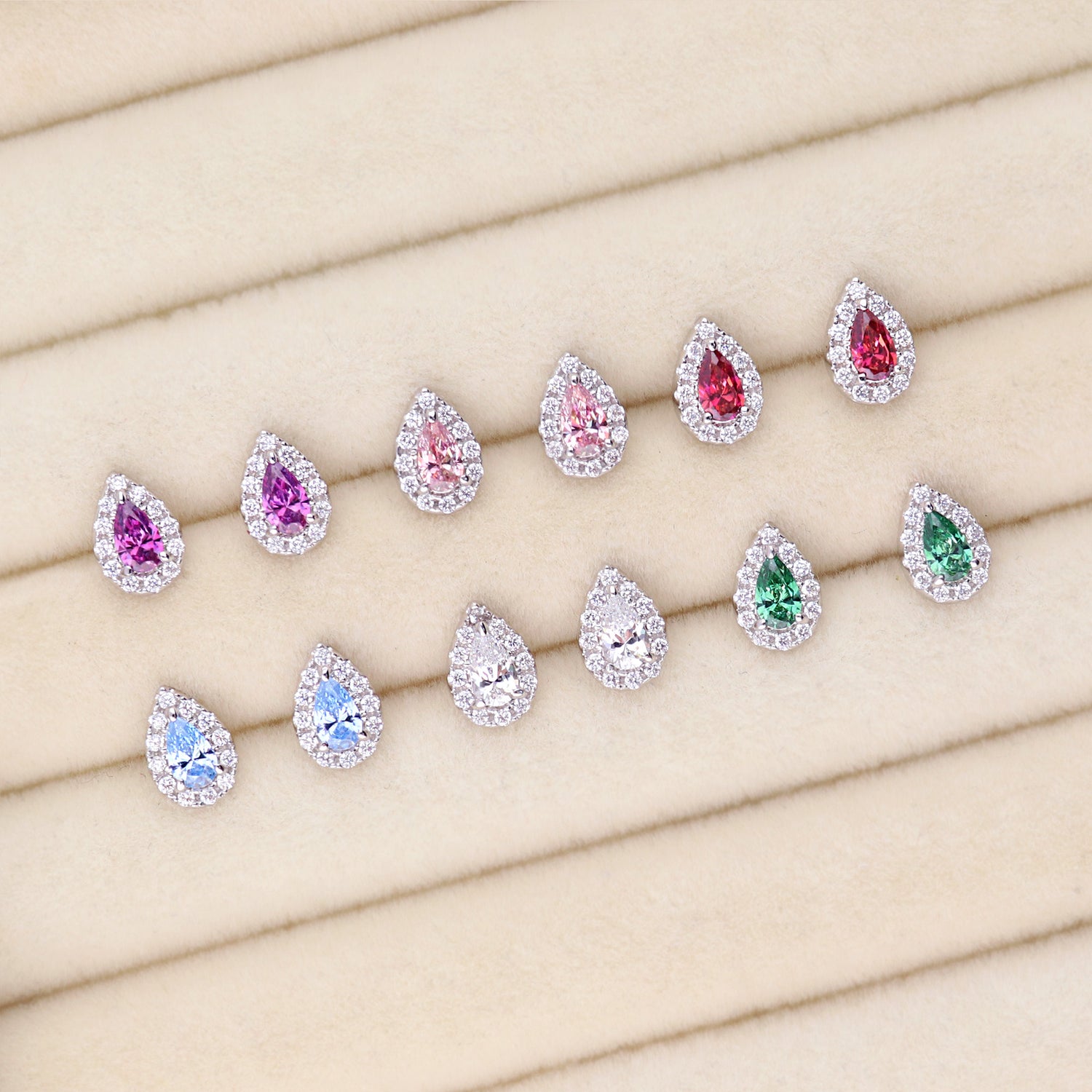 Flatlay view of Halo Pear CZ Stud Earrings in Sterling Silver