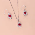 Flatlay view of Heart Flower CZ Fish Hook Earrings in Sterling Silver, Ruby Color