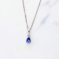 Flatlay view of Solitaire 1ct Pear CZ Necklace in Sterling Silver, Garnet Color