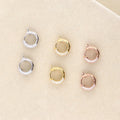 Flatlay view of Dome CZ Mini Cartilage Huggie Earrings in Sterling Silver 0.5 inch