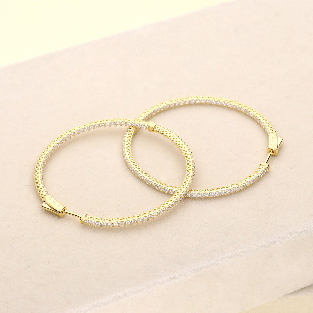 Flatlay view of CZ Large Inside-Out Hoop Earrings in Sterling Silver 2 inch, Yellow Gold Flashed