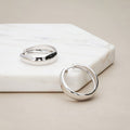 Flatlay view of Dome Small Hoop Earrings in Sterling Silver 0.8-1 inch, 2 Pairs, Rhodium Plated