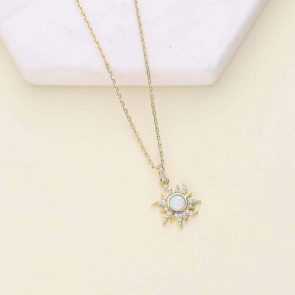Flatlay view of Sunburst Halo Simulated Opal CZ Necklace in Sterling Silver, Yellow Gold Flashed