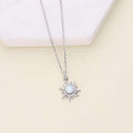 Flatlay view of Sunburst Halo Simulated Opal CZ Necklace in Sterling Silver, Yellow Gold Flashed