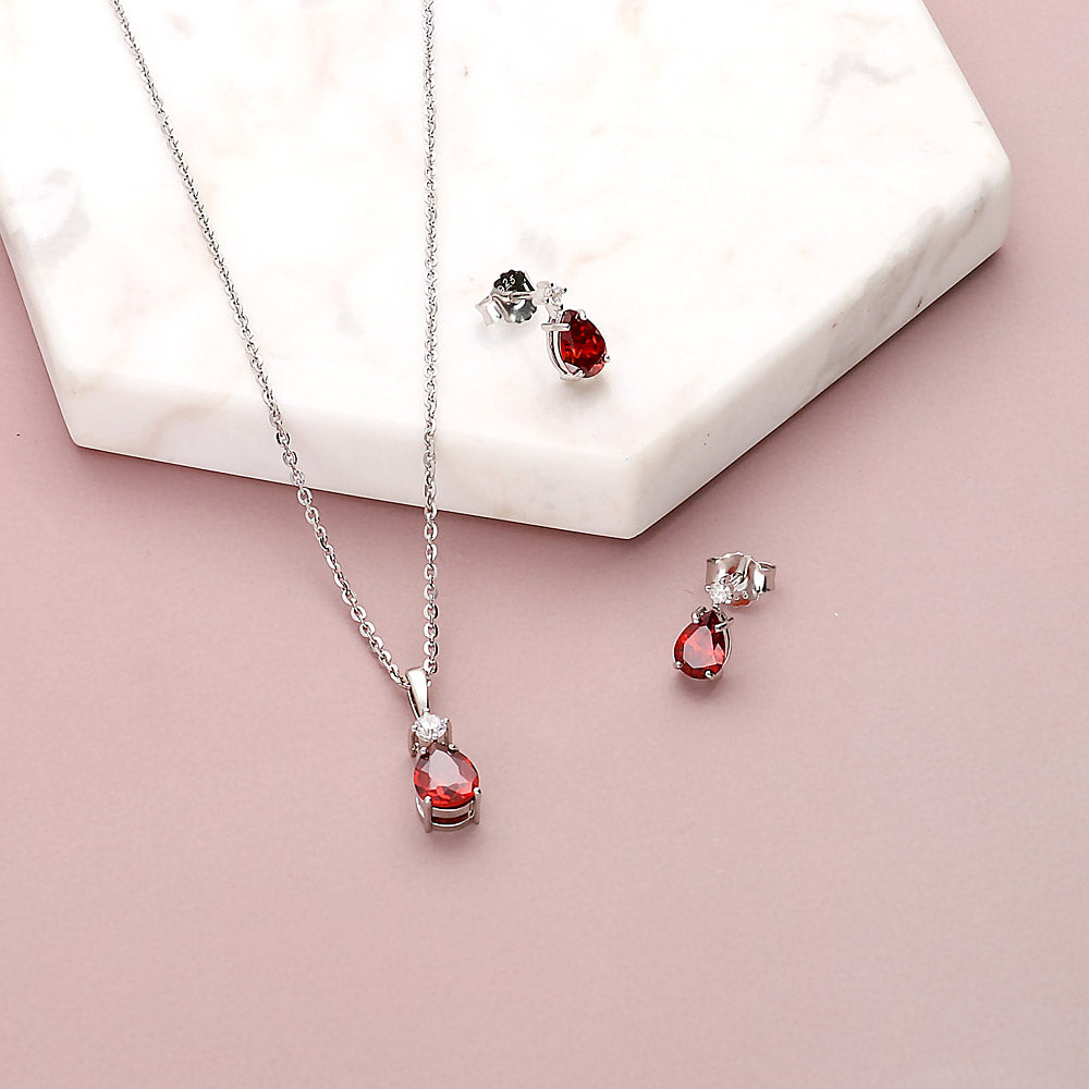 Flatlay view of Solitaire 1ct Pear CZ Necklace in Sterling Silver, Garnet Color