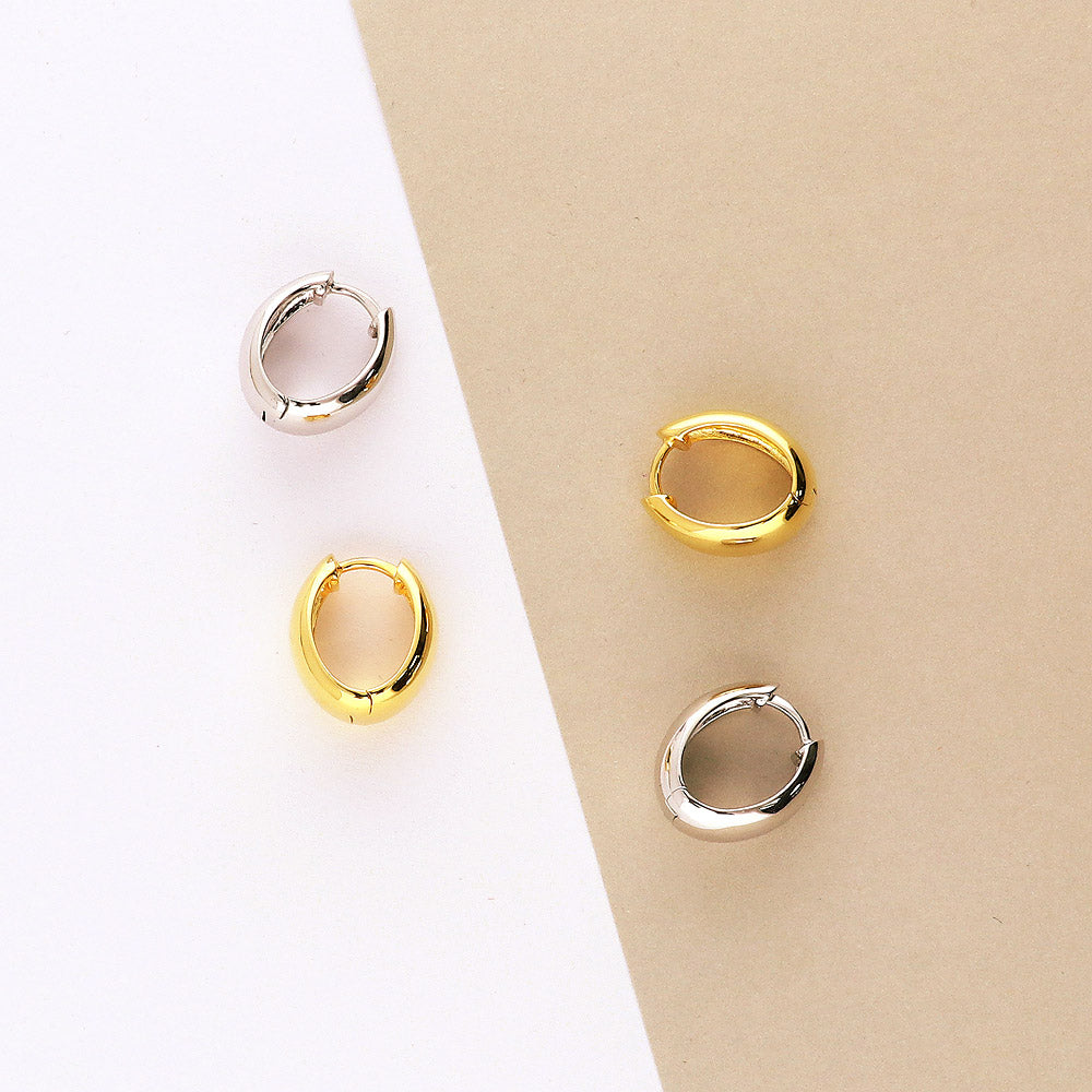 Flatlay view of Oval Dome Small Huggie Earrings in Sterling Silver 0.6 inch