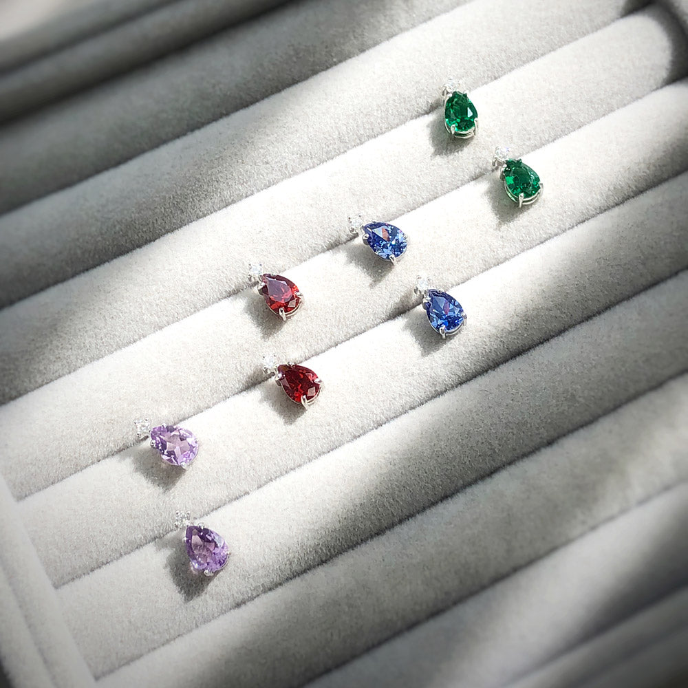 Flatlay view of Solitaire 2-Stone 1.4ct Pear CZ Stud Earrings in Sterling Silver