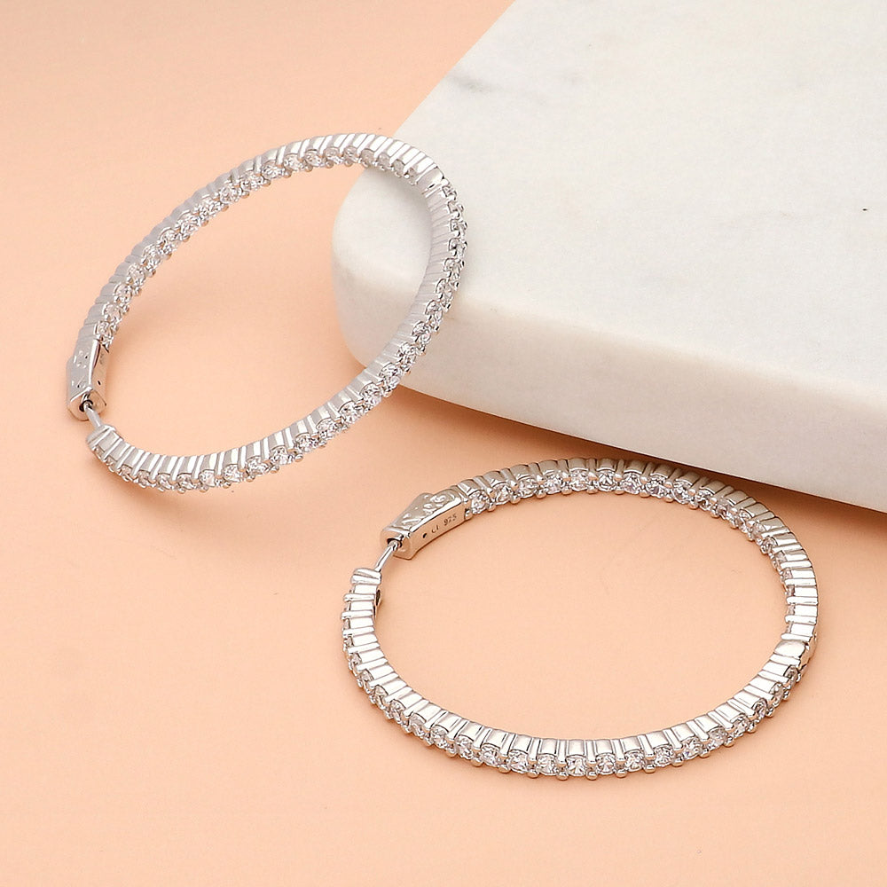Flatlay view of CZ Inside-Out Hoop Earrings in Sterling Silver 1.8 inch, Yellow Gold Flashed
