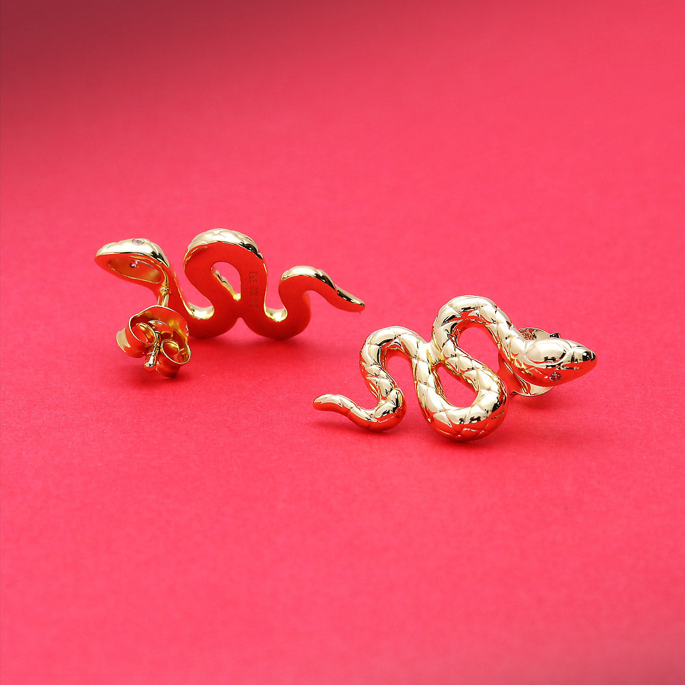 Flatlay view of Snake CZ Stud Earrings in Sterling Silver, Yellow Gold Flashed