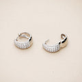 Flatlay view of Dome CZ Small Huggie Earrings in Sterling Silver 0.6 inch, Rhodium Plated, Cubic Zirconia