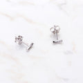 Flatlay view of Bar CZ Stud Earrings in Sterling Silver, Yellow Gold Flashed