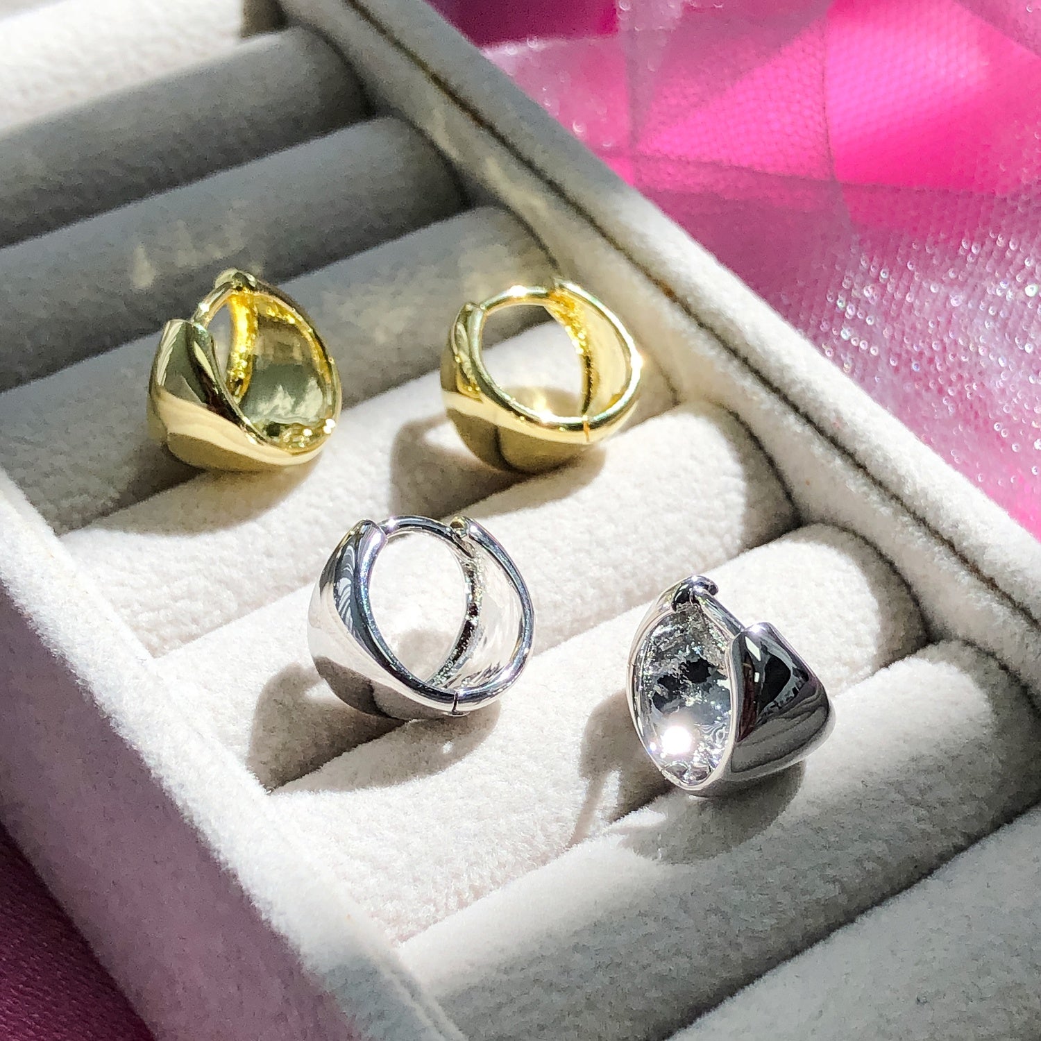 Flatlay view of Dome Mini Huggie Earrings 0.5 inch