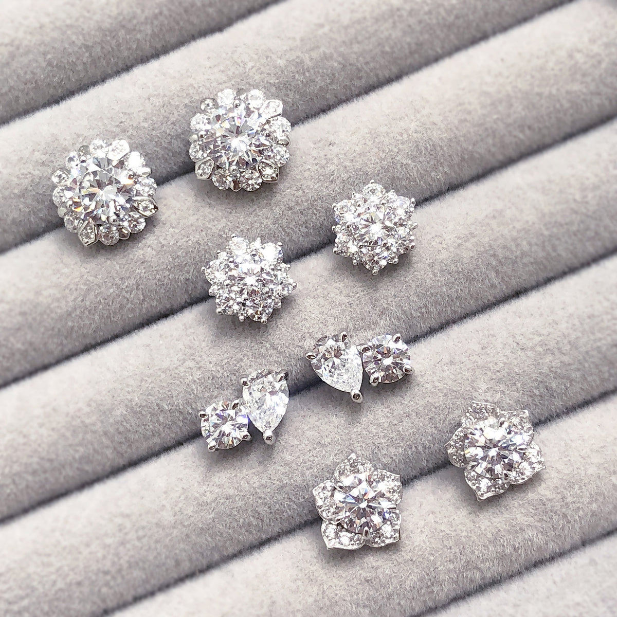 2-Stone Stud Earrings Style E1692-01, Flower Stud Earrings Style E1198-01 in Flatlay Display