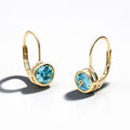 Angle view of Solitaire 1.2ct Bezel CZ Earrings in Sterling Silver, Aquamarine, Gold Plated