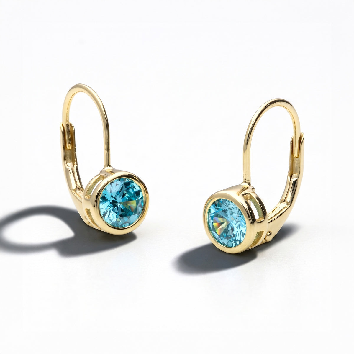 Angle view of Solitaire 1.2ct Bezel CZ Earrings in Sterling Silver, Aquamarine, Gold Plated