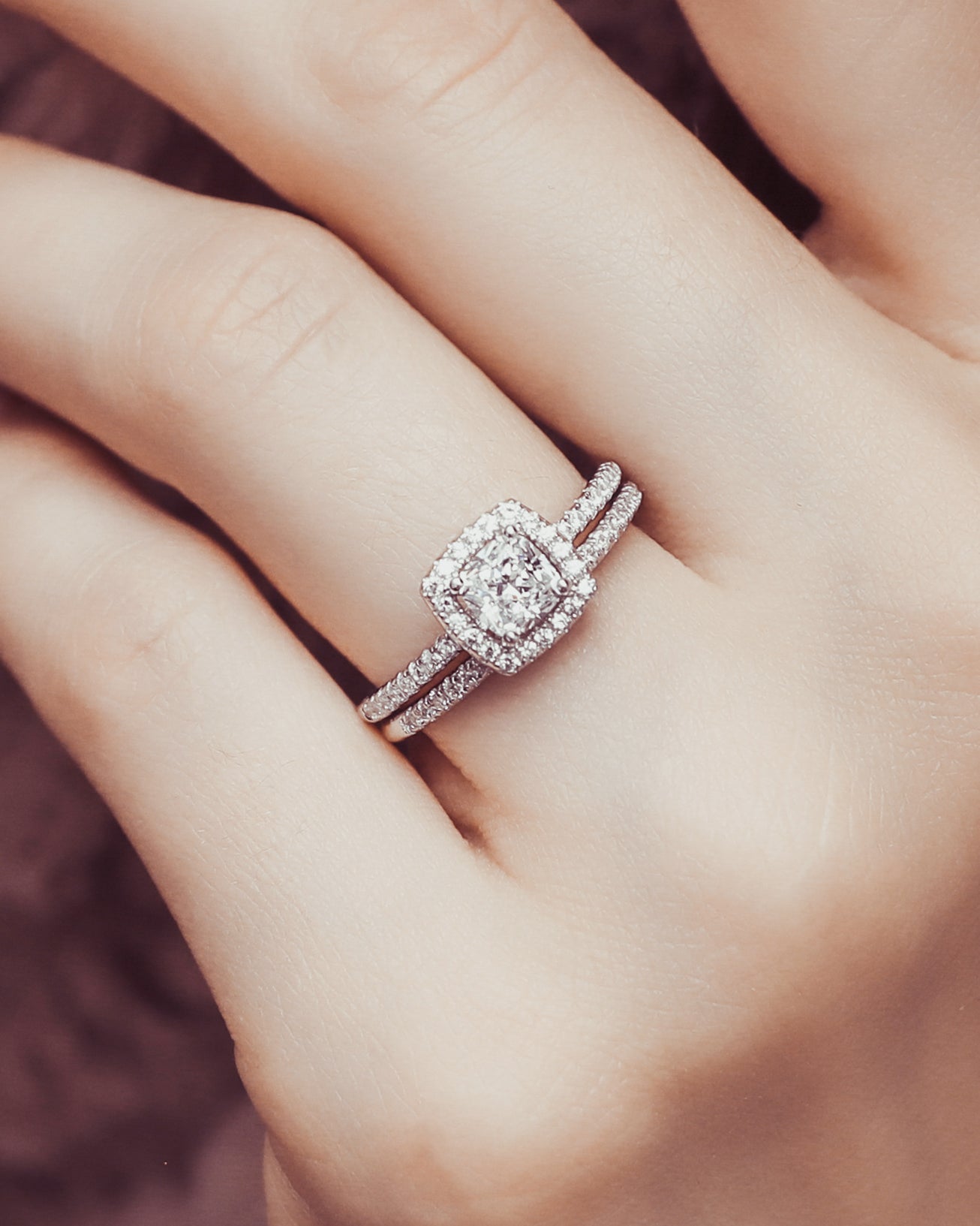 Petite cushion ring set on a finger