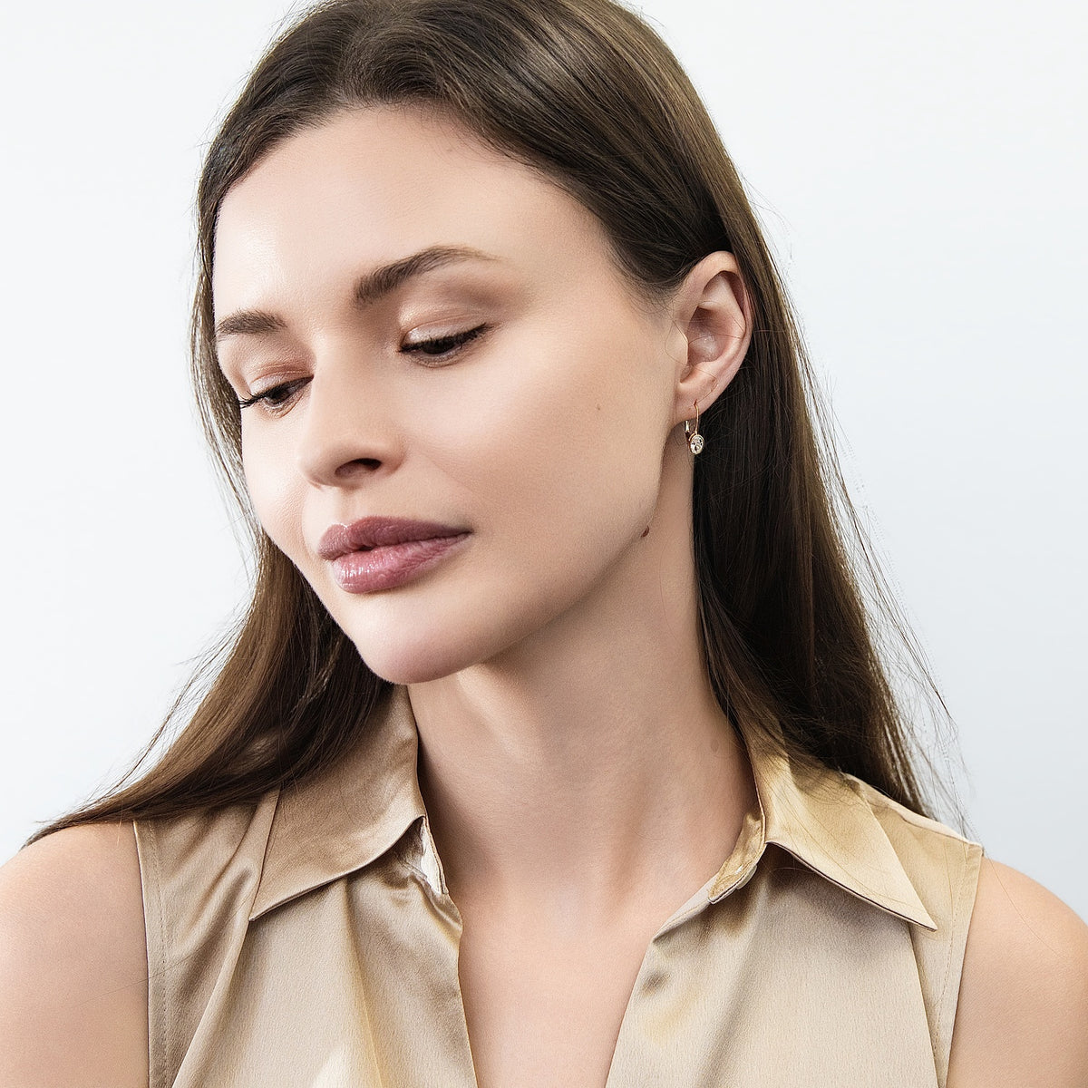 Model wearing Solitaire Oval Oval CZ Leverback Earrings in Sterling Silver, Gold Plated