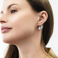 Model wearing Solitaire 2.6ct Pear CZ Leverback Earrings in Sterling Silver, Rhodium Plated