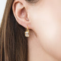Model wearing Solitaire Emerald Cut CZ Leverback Earrings in Sterling Silver, Gold Plated