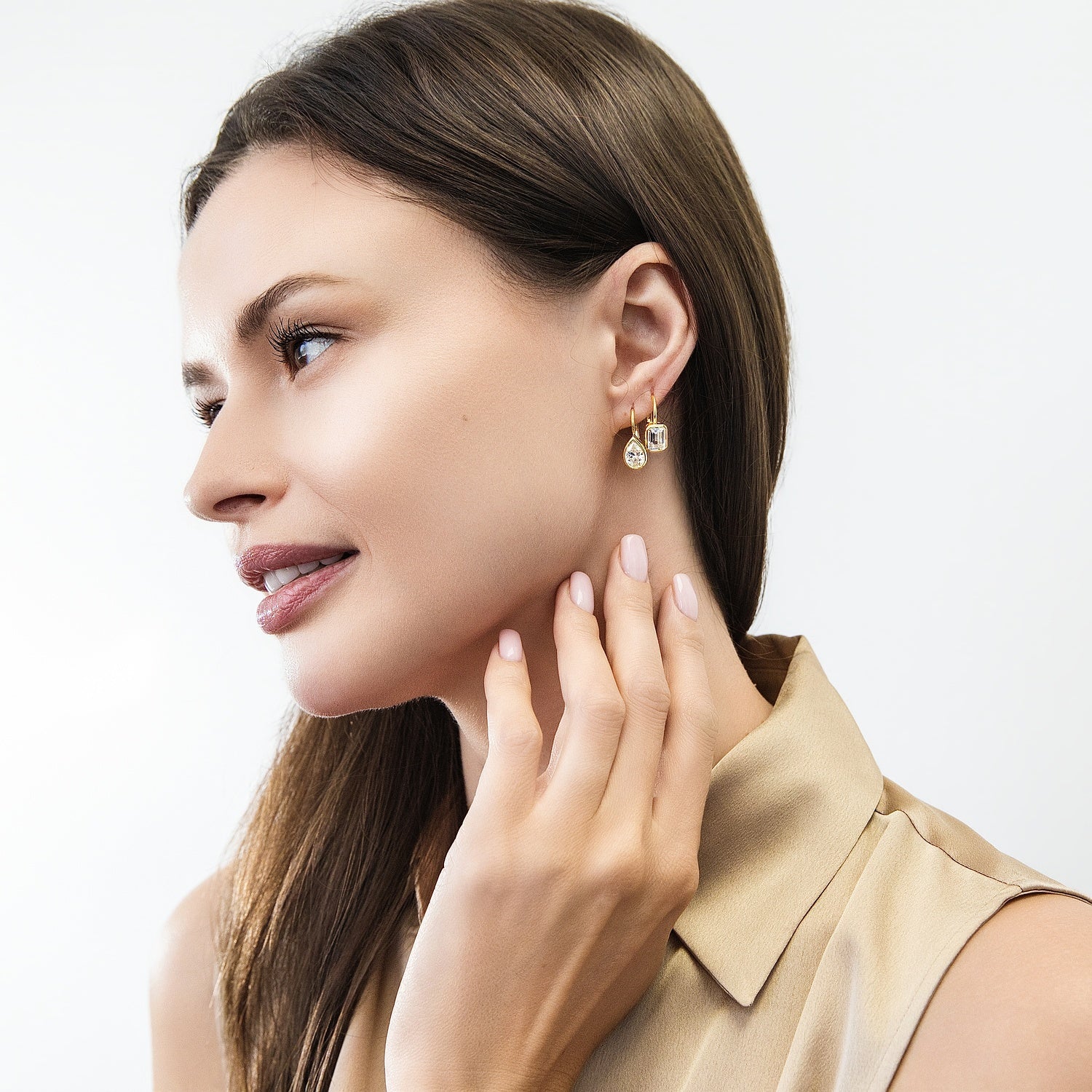 Model wearing Solitaire 2.6ct Pear CZ Leverback Earrings in Sterling Silver, Gold Flashed