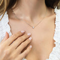 Model wearing Solitaire Bezel CZ Necklace in Sterling Silver, Rhodium Plated