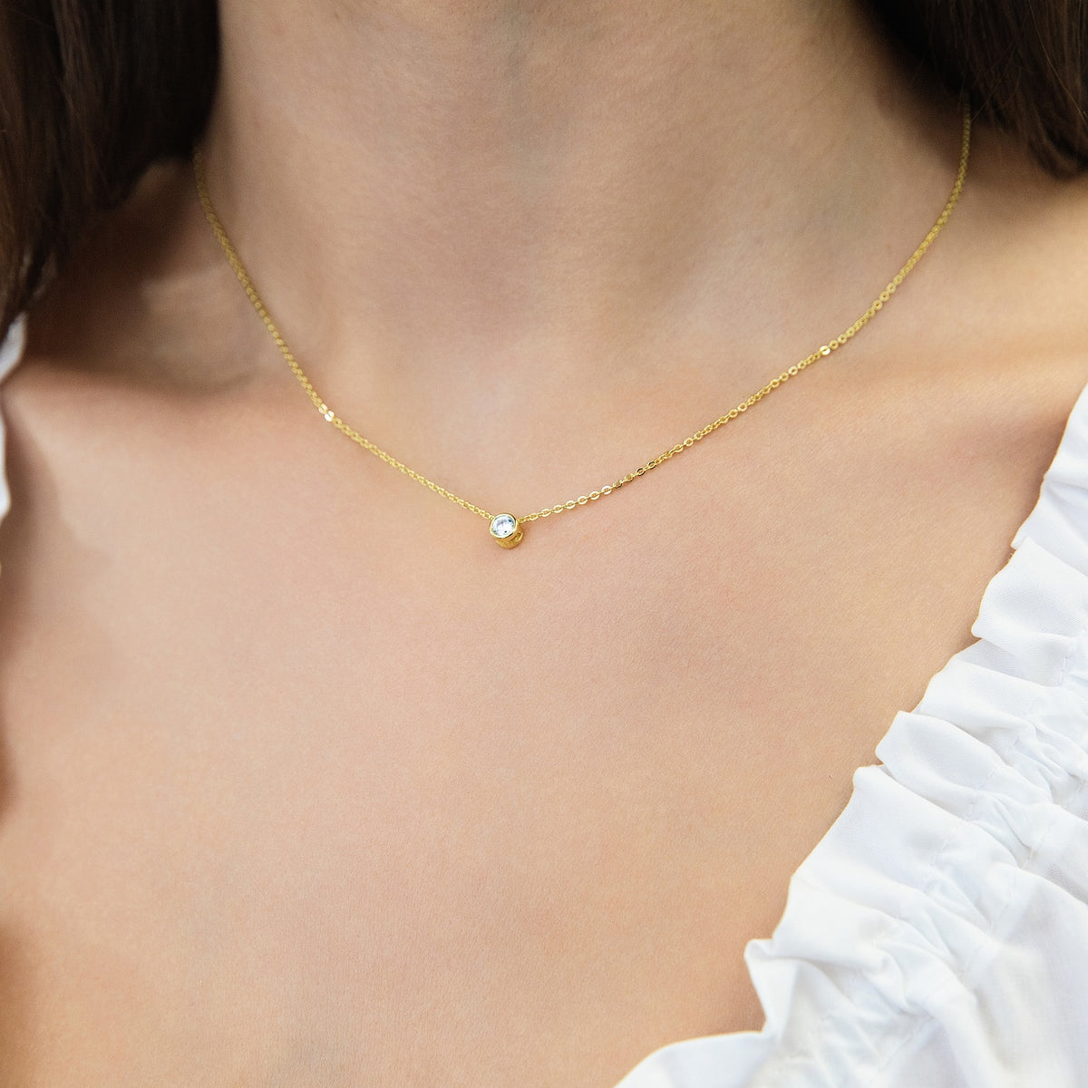 Model wearing Solitaire Bezel CZ Necklace in Sterling Silver, Gold Flashed