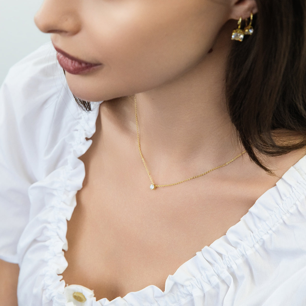 Model wearing Solitaire Bezel CZ Necklace in Sterling Silver, Gold Flashed