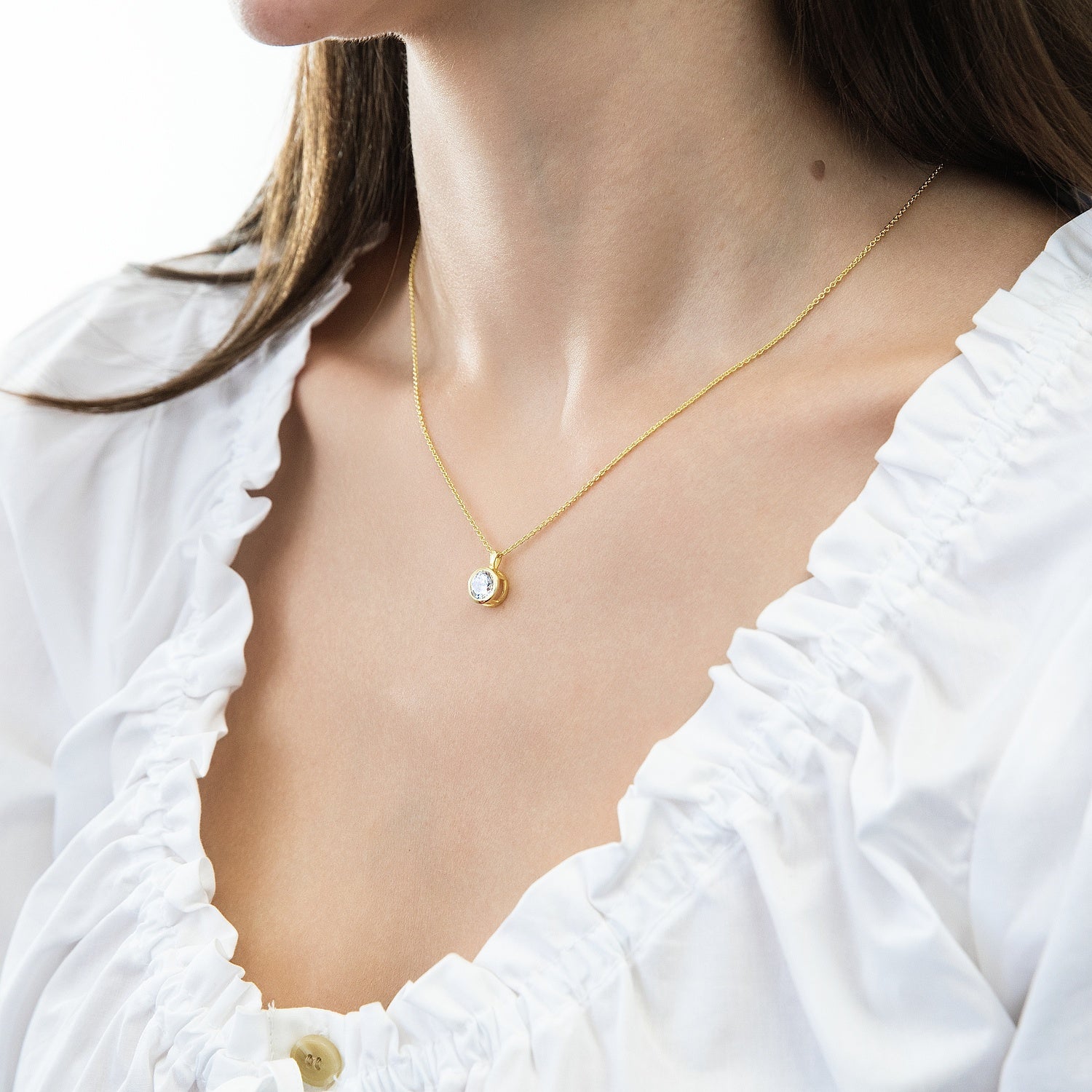 Model wearing Solitaire 1.25ct Bezel CZ Necklace in Sterling Silver, Gold Flashed