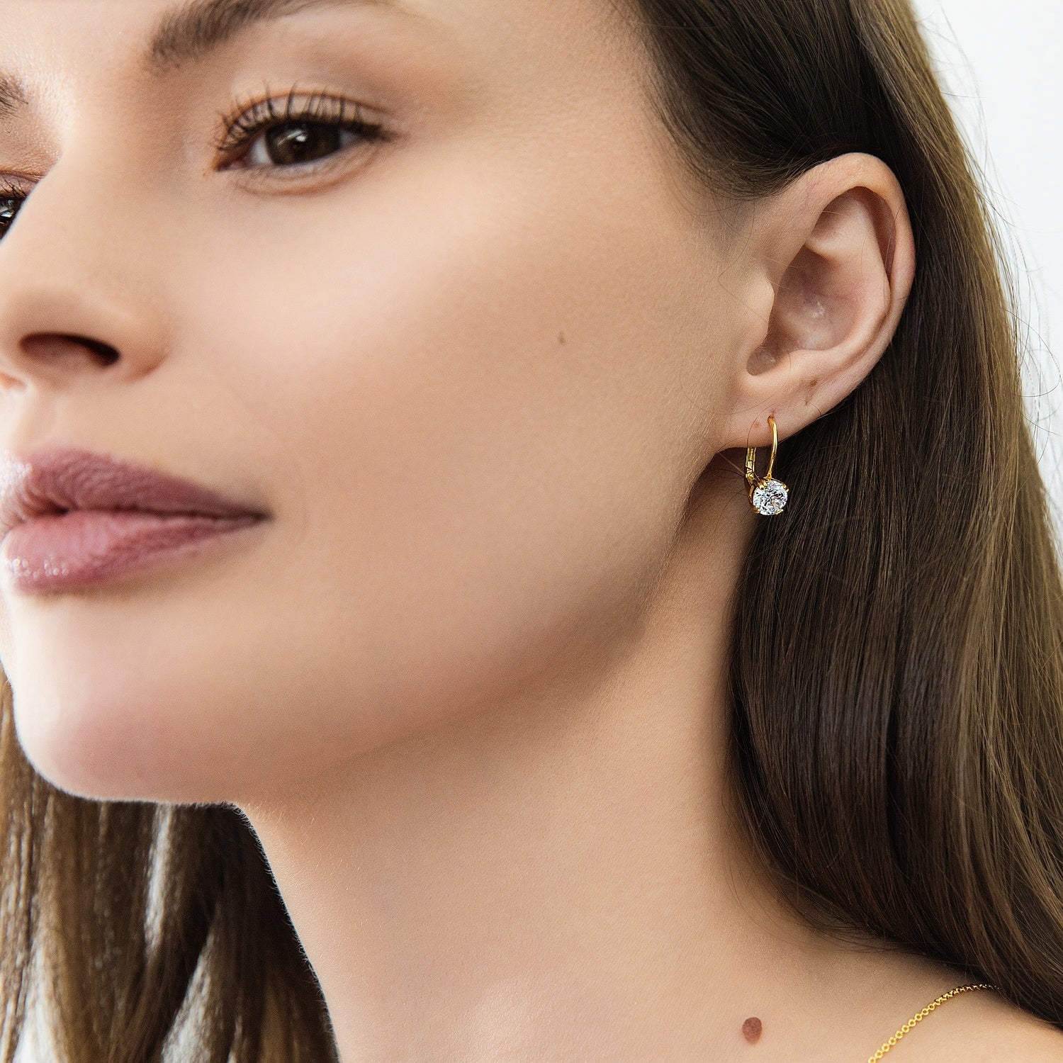 Model wearing Solitaire CZ Leverback Earrings in Sterling Silver, Gold Flashed / 6mm