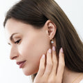 Model wearing Solitaire CZ Leverback Earrings in Sterling Silver, Gold Flashed / 6mm