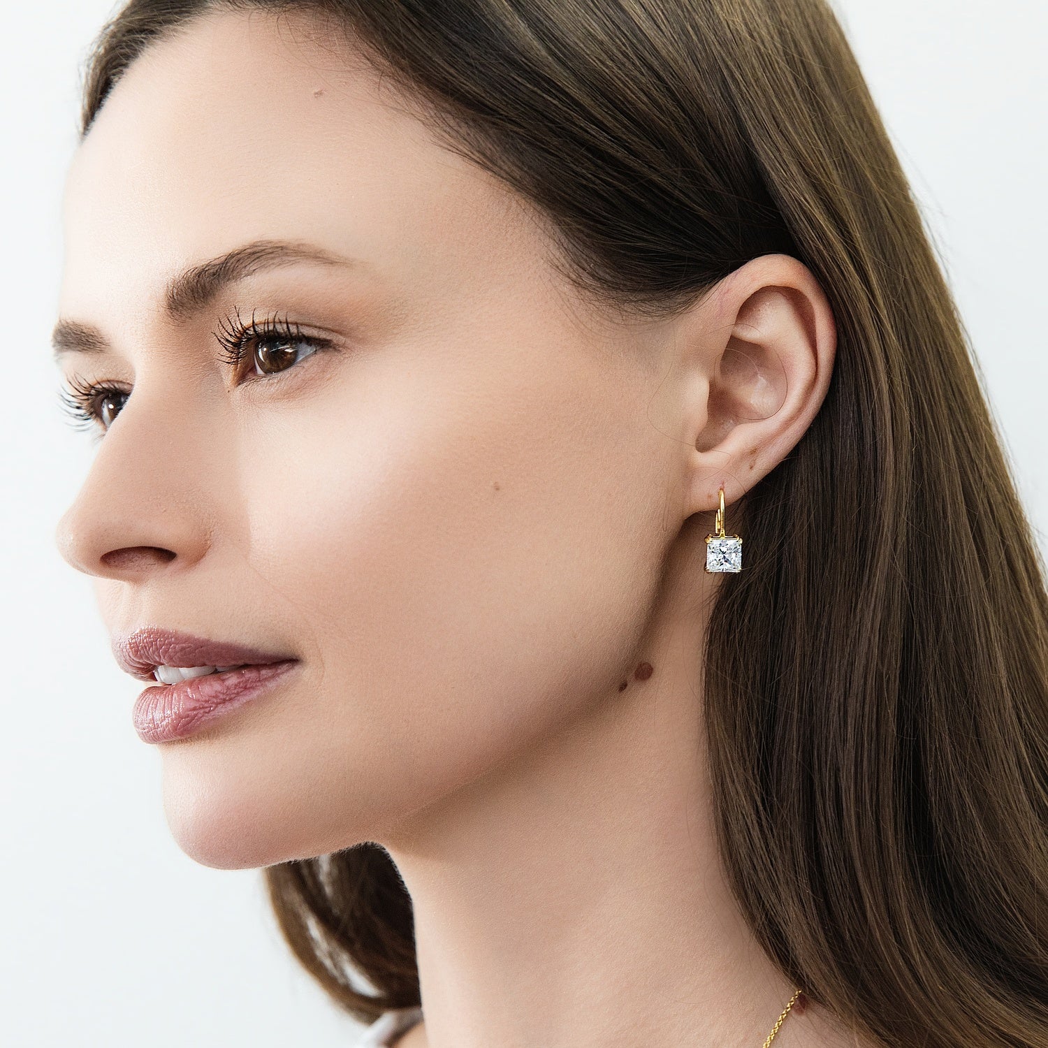 Model wearing Solitaire 4ct Princess CZ Leverback Earrings in Sterling Silver, Gold Flashed