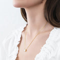 Model wearing Solitaire East-West Emerald Cut CZ Necklace in Sterling Silver, Gold Flashed