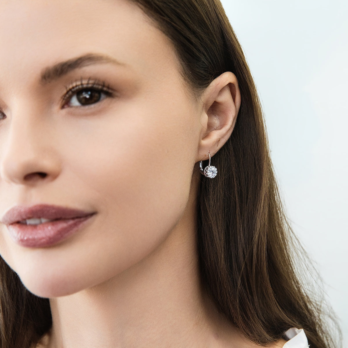 Model wearing Solitaire 2ct Crown Set CZ Earrings in Sterling Silver, Rhodium Plated