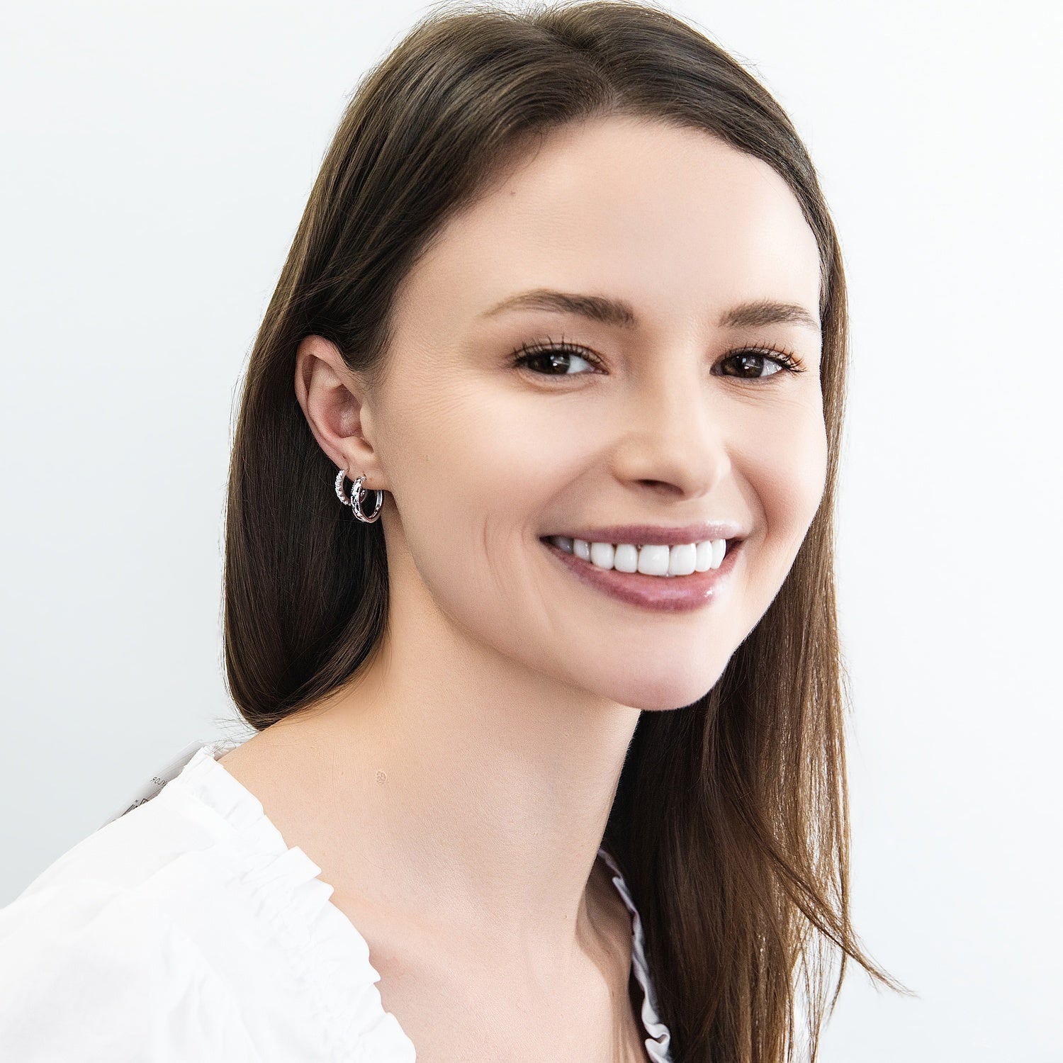 Model wearing 7-Stone CZ Small Hoop Earrings in Sterling Silver 0.6 inch, 5 of 9