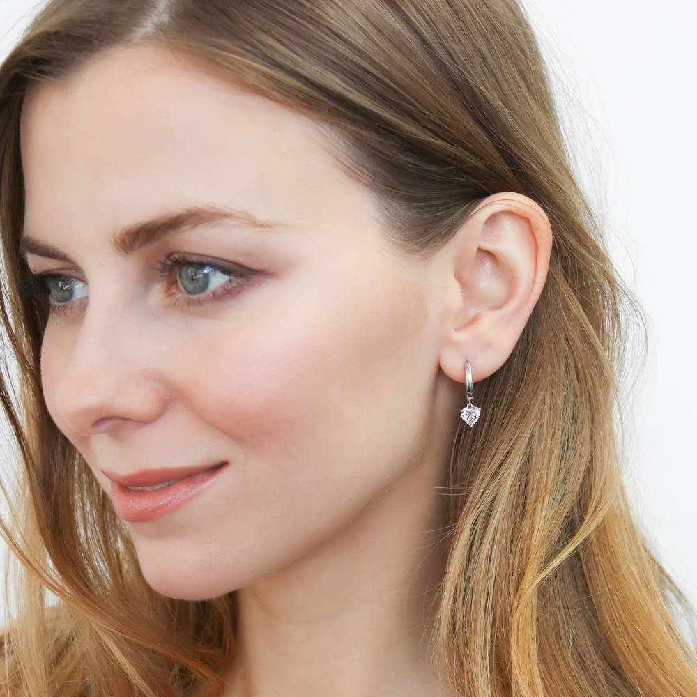 Model wearing Solitaire CZ Cartilage Huggie Earrings in Sterling Silver 0.5 inch, Heart Shaped Cut