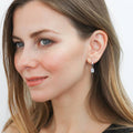 Model wearing Solitaire CZ Cartilage Huggie Earrings in Sterling Silver 0.5 inch, Emerald Cut