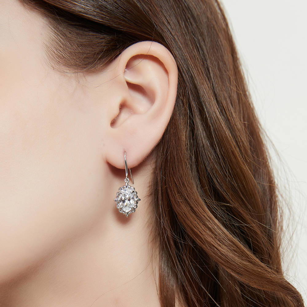 Model wearing Solitaire Filigree Oval CZ Fish Hook Earrings in Sterling Silver, 6 of 8