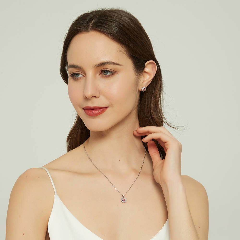 Model wearing Halo Kaleidoscope CZ Stud Earrings in Sterling Silver, Red Orange