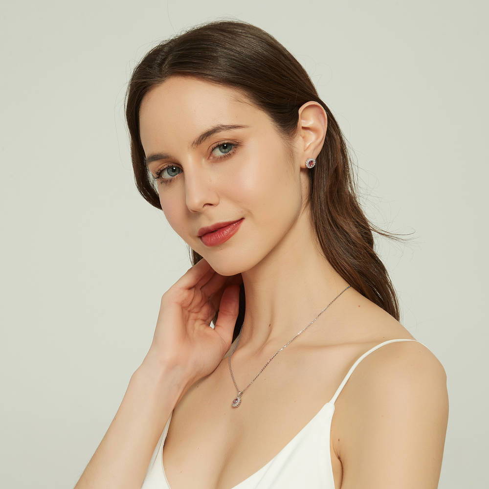Model wearing Halo Kaleidoscope CZ Stud Earrings in Sterling Silver, Red Orange