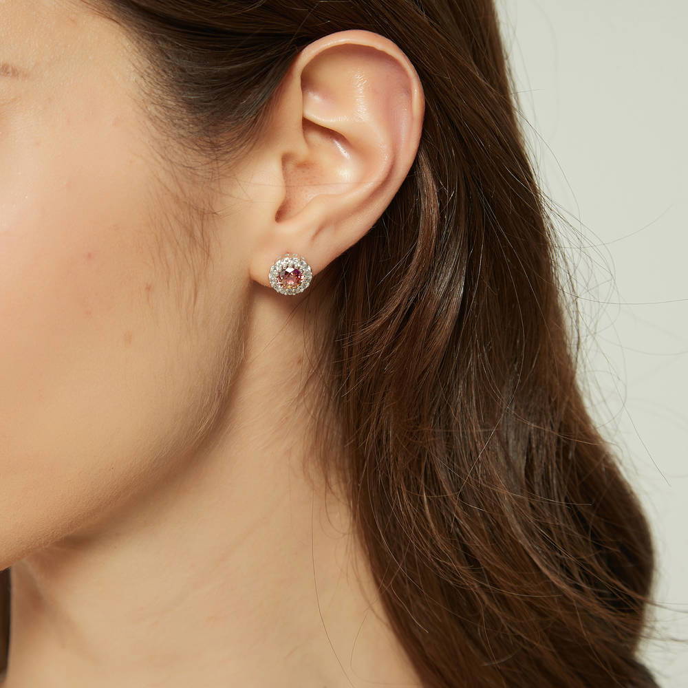Model wearing Halo Kaleidoscope CZ Stud Earrings in Sterling Silver, Red Orange