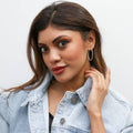 Model wearing Oval CZ Inside-Out Hoop Earrings in Sterling Silver 1.4 inch, Rose Gold Flashed