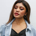Model wearing Oval CZ Inside-Out Hoop Earrings in Sterling Silver 1.4 inch, Rose Gold Flashed
