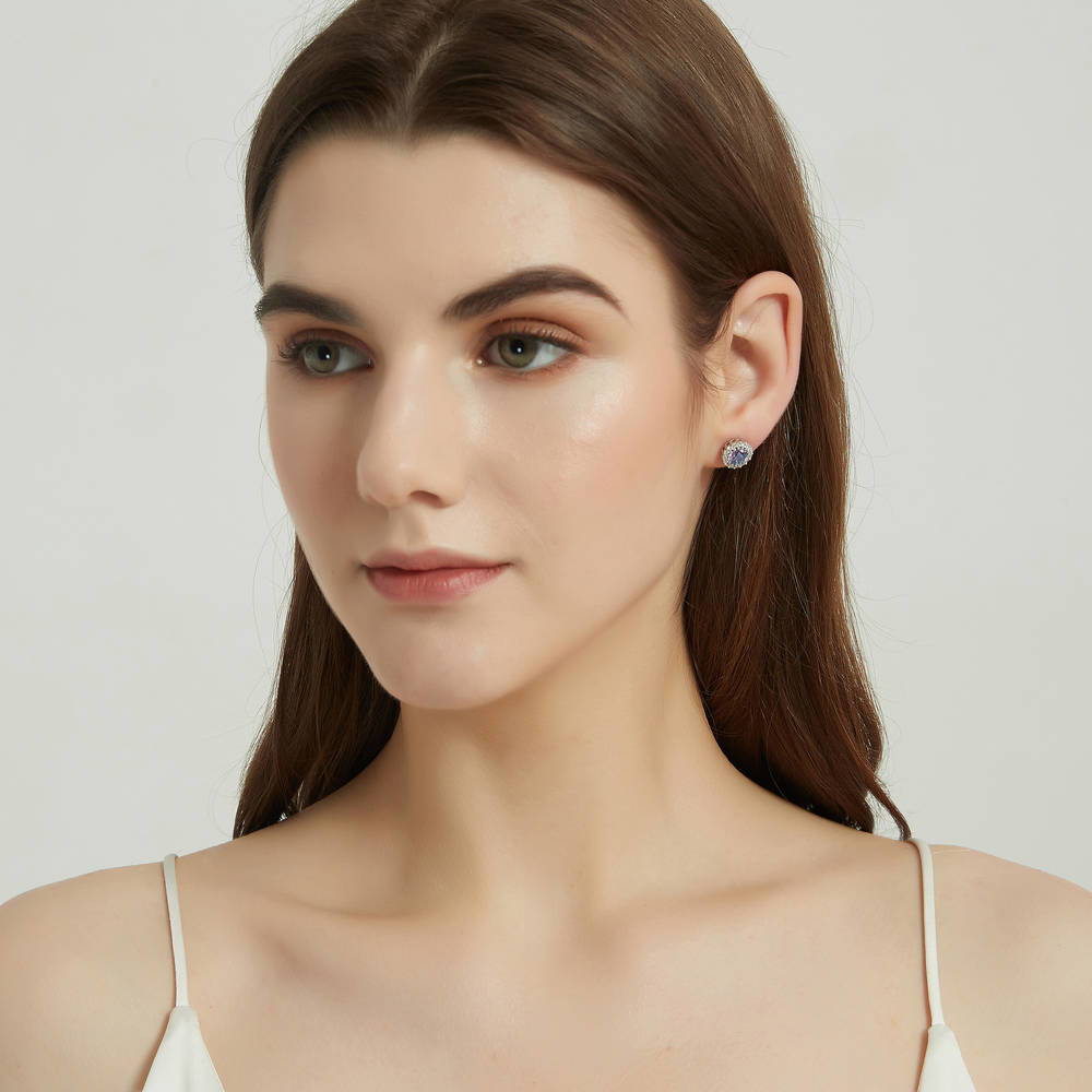 Model wearing Halo Kaleidoscope CZ Stud Earrings in Sterling Silver, Purple Aqua
