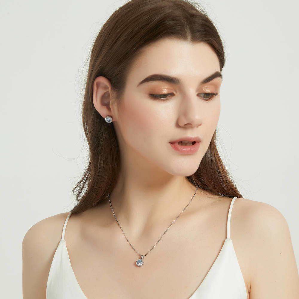 Model wearing Halo Kaleidoscope CZ Stud Earrings in Sterling Silver, Greyish Blue