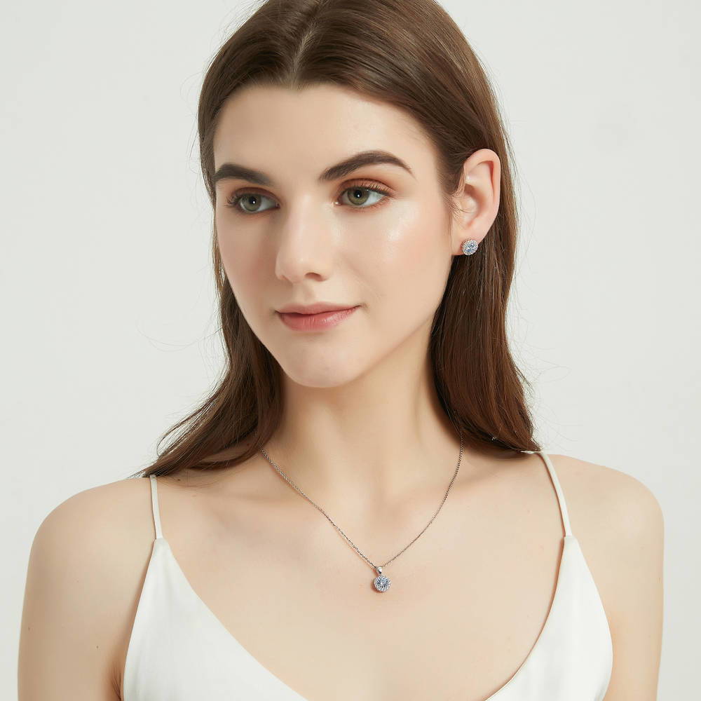 Model wearing Halo Kaleidoscope CZ Stud Earrings in Sterling Silver, Greyish Blue