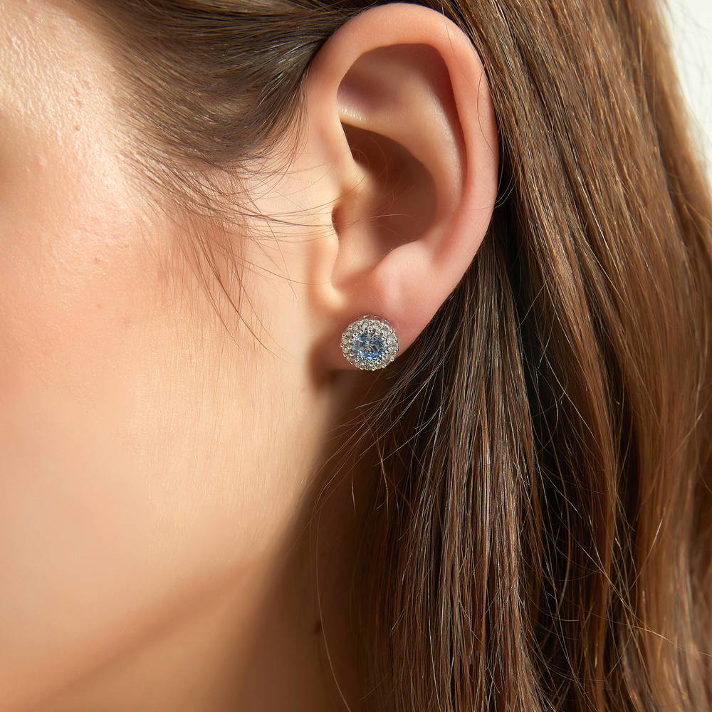 Model wearing Halo Kaleidoscope CZ Stud Earrings in Sterling Silver, Greyish Blue